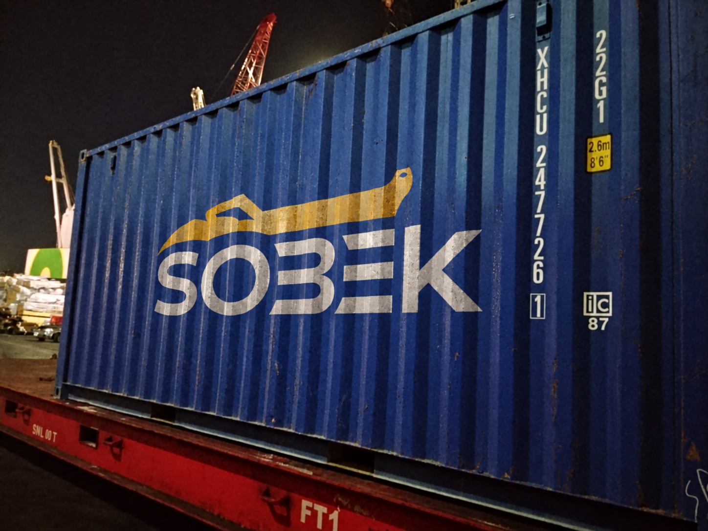 Blue Sobek container at the port at night