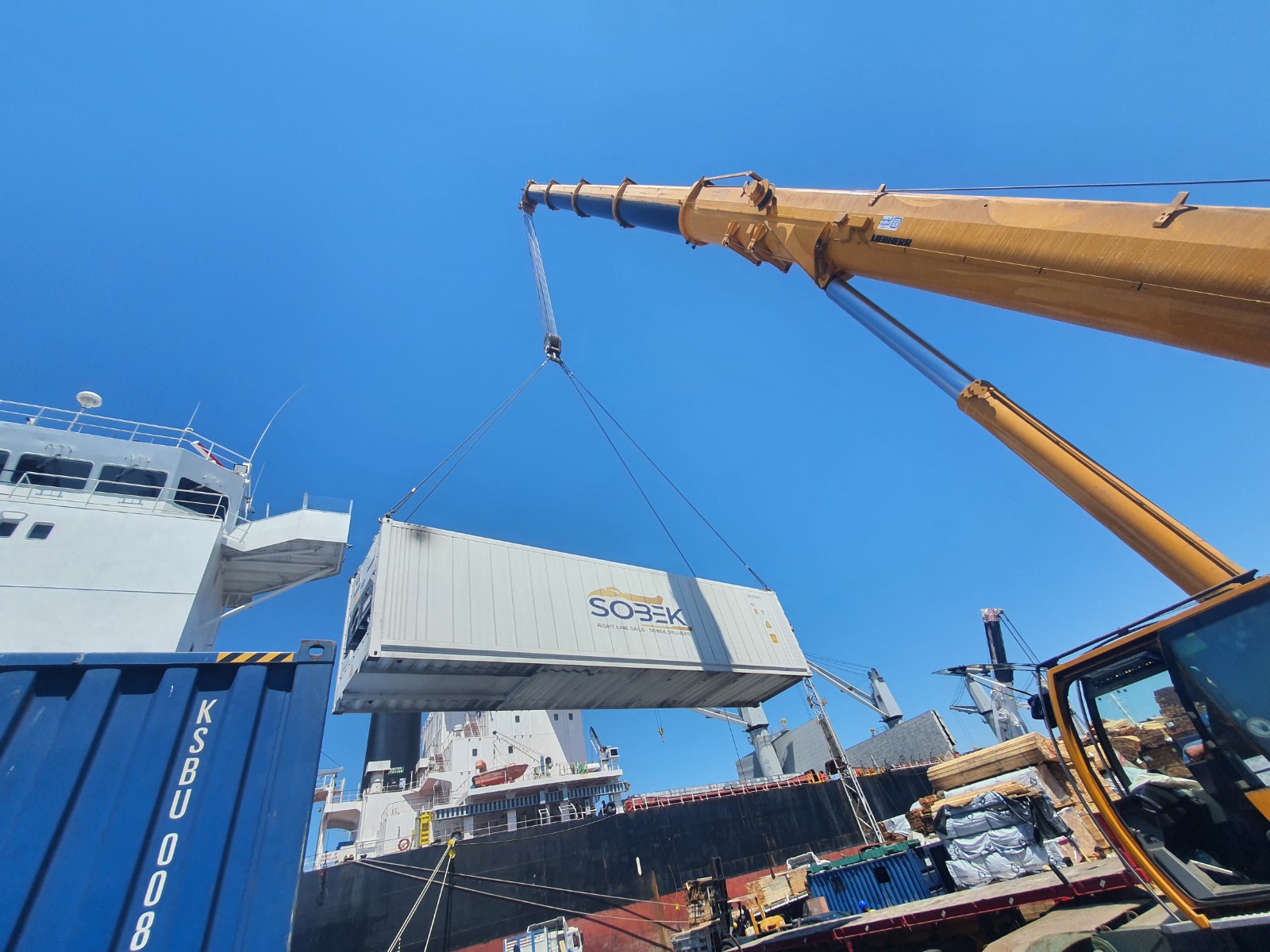 Sobek container hanging beside a cargo ship
