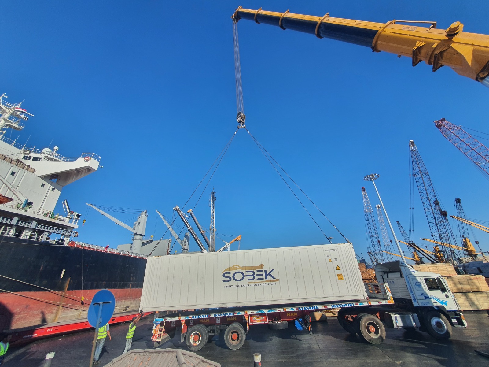 Crane loading a Sobek container beside a vessel in Alexandria