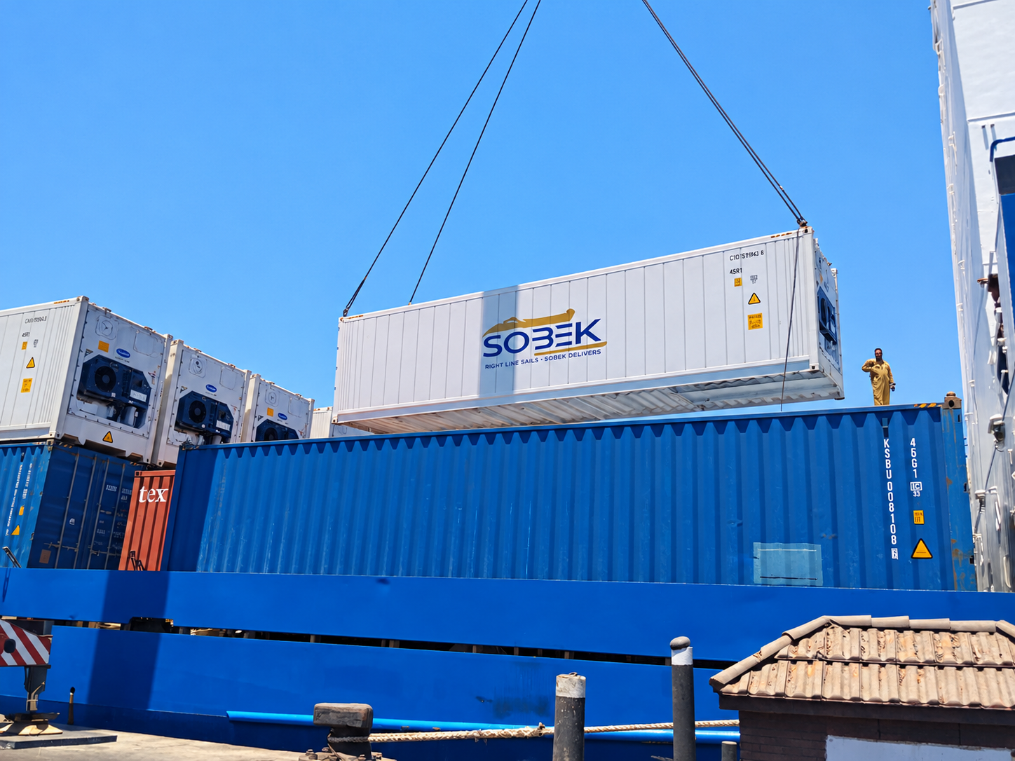 White Sobek reefer lifted above a blue container