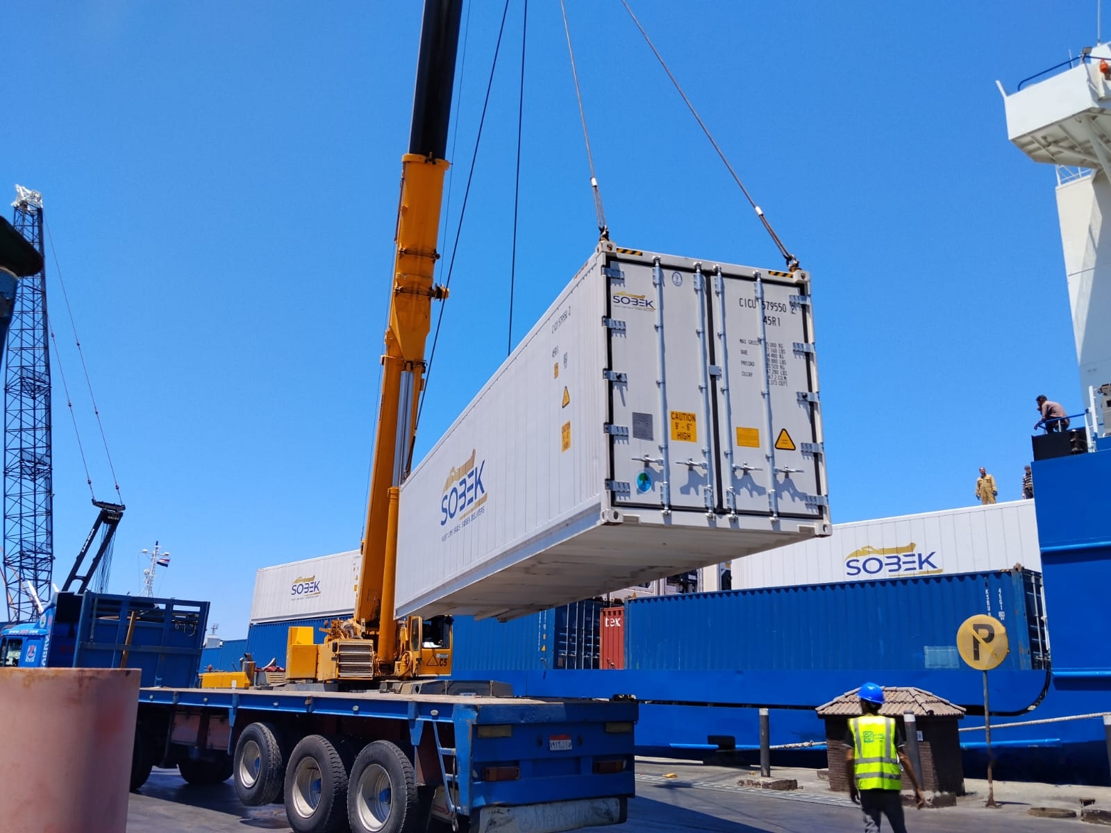 Reefer container doors facing the camera during a lift